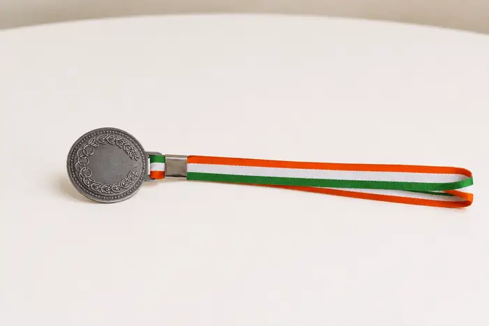 Silver award medal with tricolor ribbon